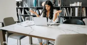 A woman is confused at her computer
