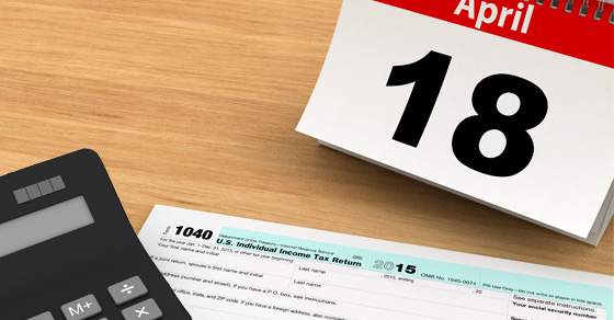 Photo of tax date, calculator and 1040 form.