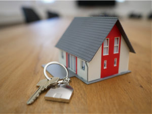 little model house with keys, on table