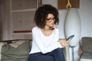 Woman sitting and looking at her cellphone