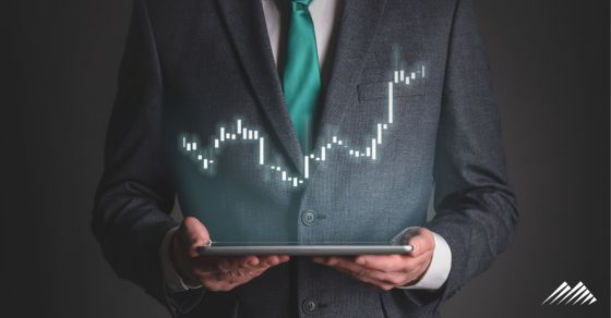 man holding tablet with stocks