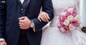 A married couple walks arm in arm