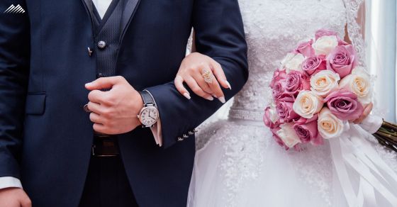 A married couple walks arm in arm