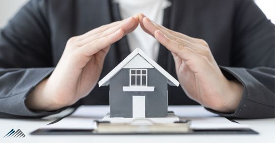 hands over a house representing homeowners insurance