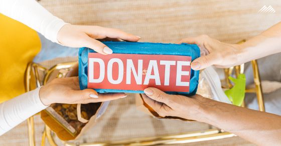 Hands hold a box that says Donate