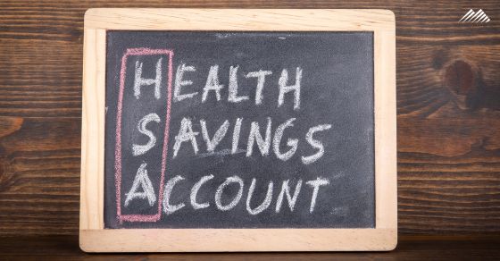 A chalkboard with the words Health Savings Account written in chalk