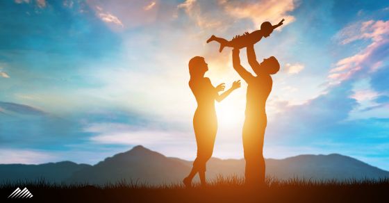 Happy family near mountains at twilight