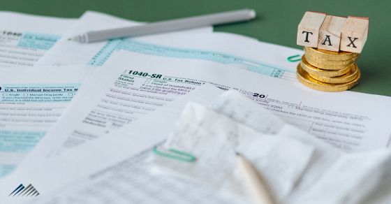 Tax paperwork piled on a desk