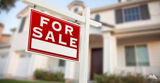 Home with a for sale sign in front
