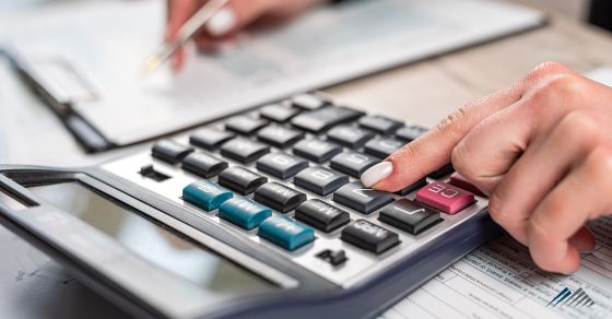 a hand with a calculator
