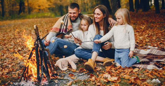family roasting marshmallows over campfire