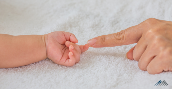 baby's and mom's fingers touch