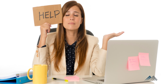 A woman in an office holding a sign that says "help."