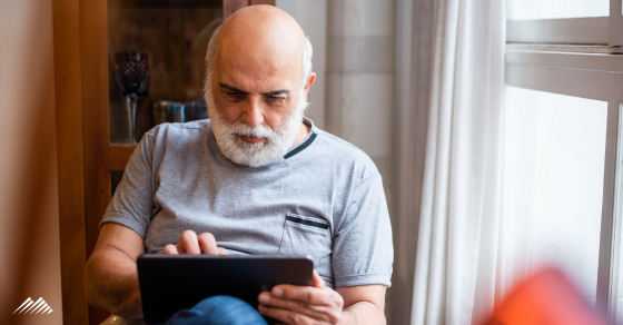 A senior man working on a tablet