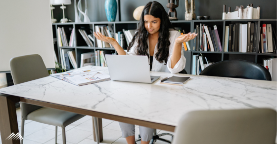 A woman is confused at her computer