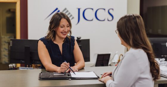 A JCCS team member helping a client