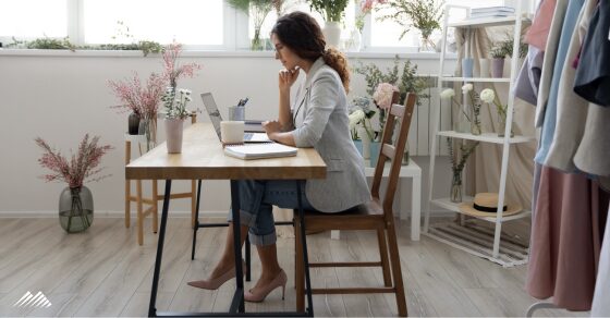 A woman sitting at her desk and looking over paperwork