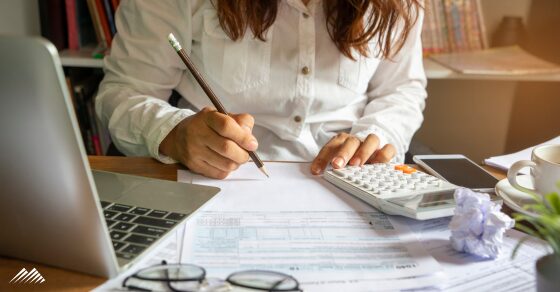 A woman doing taxes at her desk