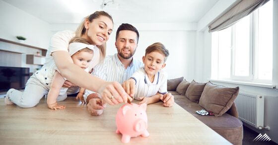 A family putting money in a piggy bank