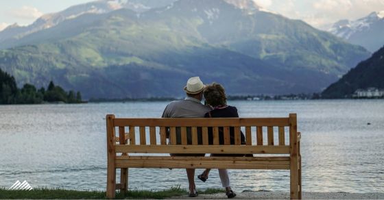 A couple on a bench in the mountains