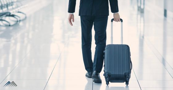 A businessman pulling a suitcase
