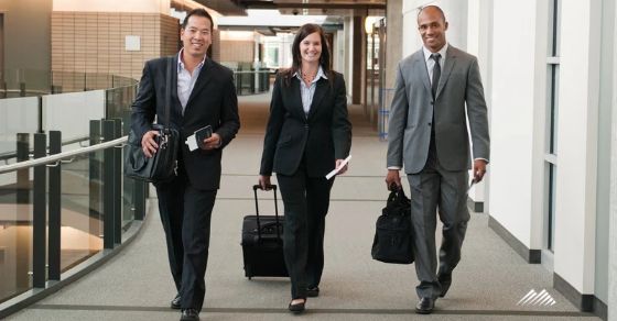 Three professionals with suitcases